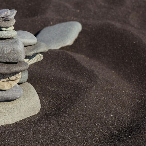 A balanced stack of stones on a serene background, symbolizing stability.